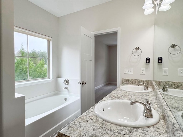 full bathroom featuring a bath, double vanity, and a sink