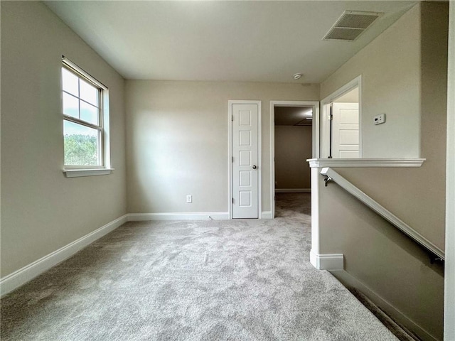 interior space featuring visible vents, a walk in closet, a closet, carpet floors, and baseboards