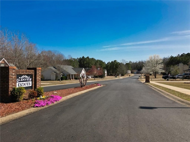 view of street with a residential view and curbs