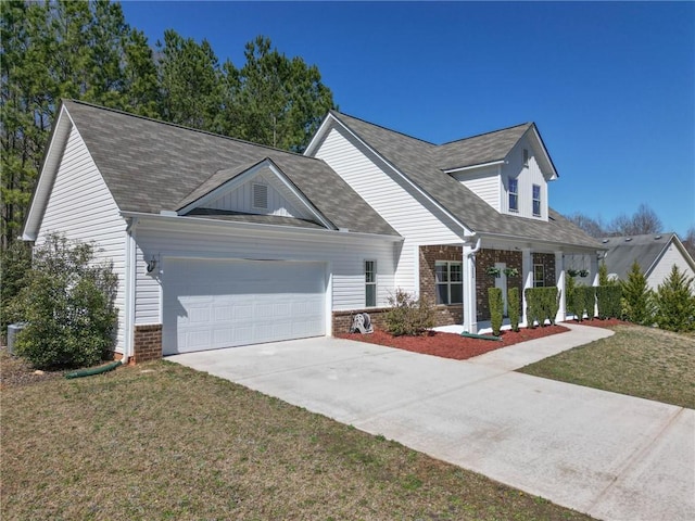 cape cod home with brick siding, an attached garage, concrete driveway, and a front yard