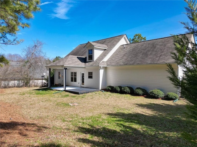 back of property with a yard, a patio area, and fence