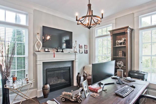 office space featuring a notable chandelier, ornamental molding, and a wealth of natural light