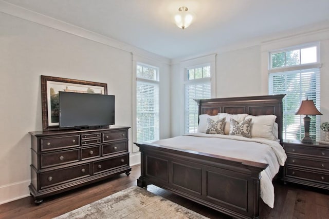 bedroom featuring dark hardwood / wood-style floors and crown molding