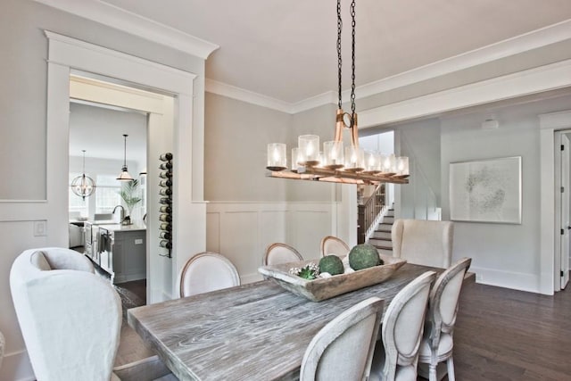 dining space with dark hardwood / wood-style flooring, an inviting chandelier, and crown molding