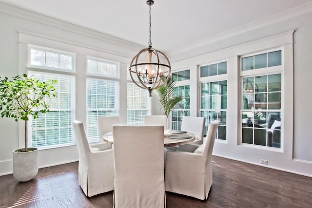 dining space featuring a notable chandelier, crown molding, and dark wood-type flooring