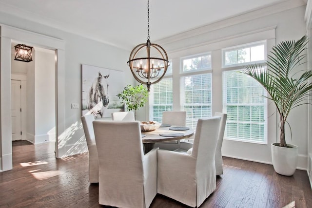 dining space with a chandelier, crown molding, and dark hardwood / wood-style flooring