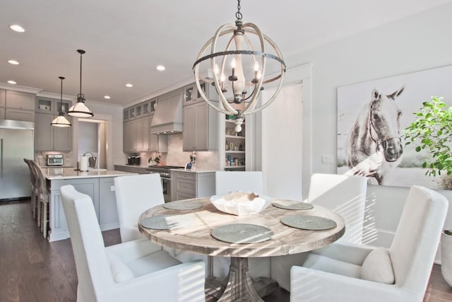 dining room featuring a notable chandelier, dark wood-type flooring, and sink