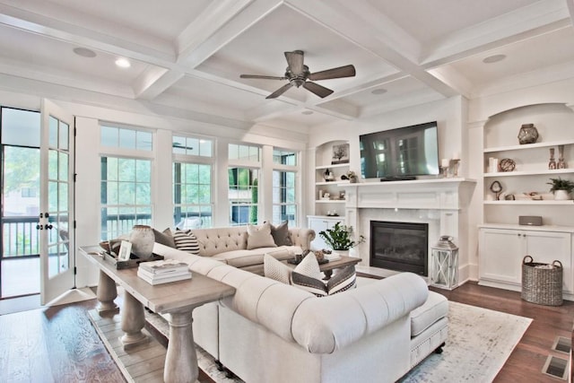 living room featuring coffered ceiling, dark wood-type flooring, and beamed ceiling