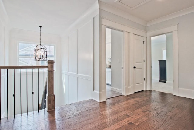 hallway with dark hardwood / wood-style flooring and an inviting chandelier