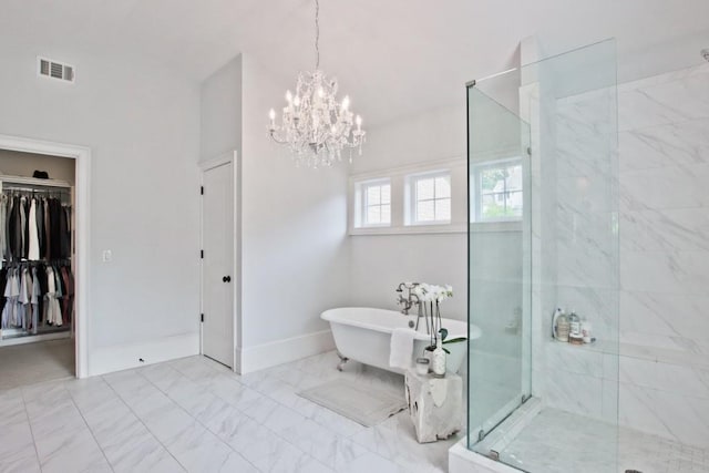 bathroom with an inviting chandelier, tile floors, and independent shower and bath