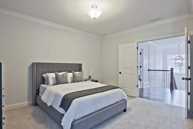 bedroom with a notable chandelier, ornamental molding, and light colored carpet