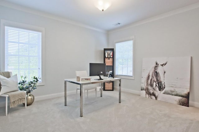 office area with crown molding, a wealth of natural light, and light colored carpet