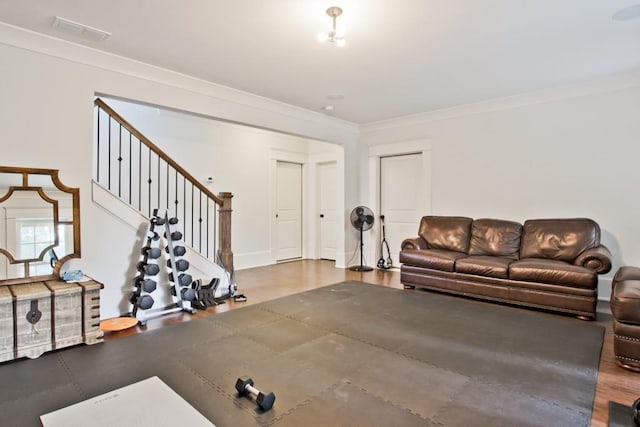 workout room featuring crown molding and dark hardwood / wood-style floors