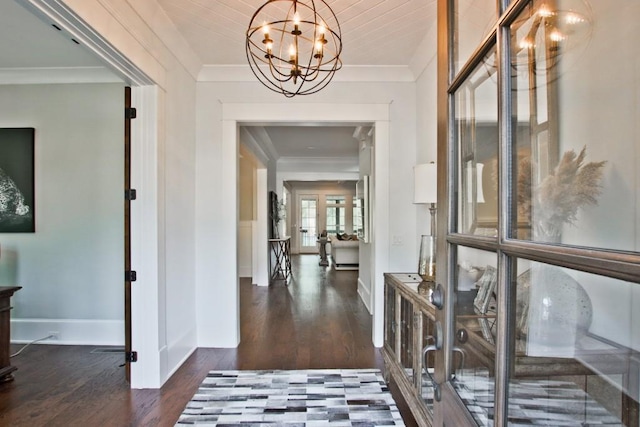 interior space with a chandelier, french doors, dark hardwood / wood-style floors, and crown molding