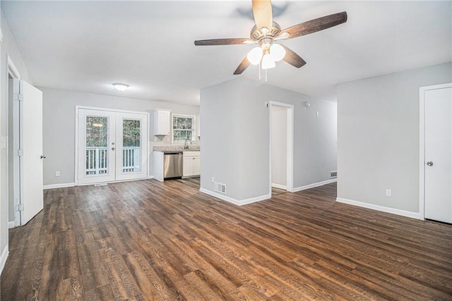 unfurnished living room featuring ceiling fan, french doors, and dark wood-type flooring