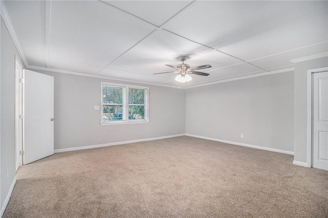 carpeted spare room featuring ceiling fan and crown molding