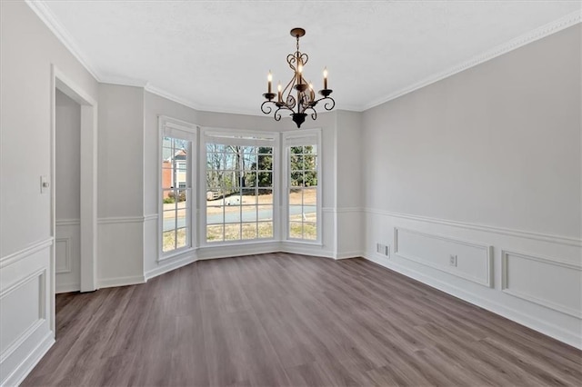 unfurnished dining area featuring ornamental molding, dark wood-style floors, visible vents, and a chandelier