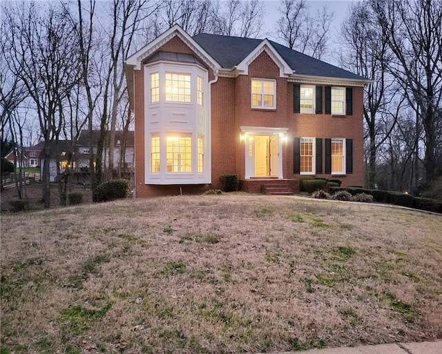 colonial inspired home with brick siding