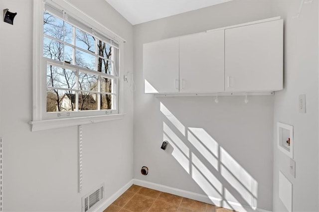 laundry area featuring hookup for a washing machine, visible vents, baseboards, cabinet space, and tile patterned flooring