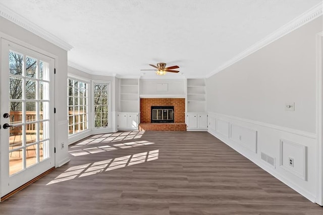 unfurnished sunroom with visible vents, a brick fireplace, and a ceiling fan