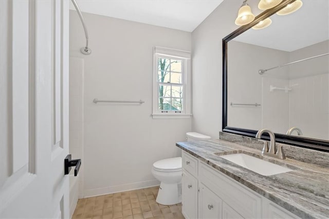 full bath with toilet, vanity, a shower, and baseboards