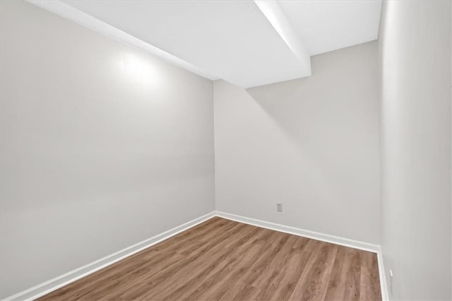 spare room featuring light wood-style flooring and baseboards