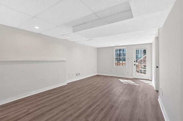 spare room featuring visible vents, baseboards, a drop ceiling, recessed lighting, and dark wood-style floors