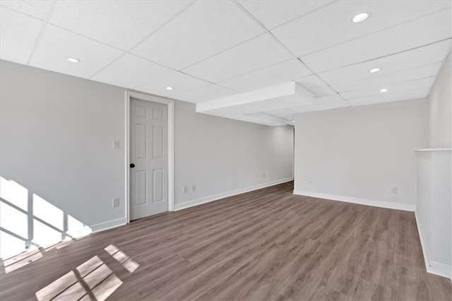 interior space featuring baseboards and wood finished floors