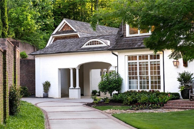 view of front of home featuring brick siding and covered porch