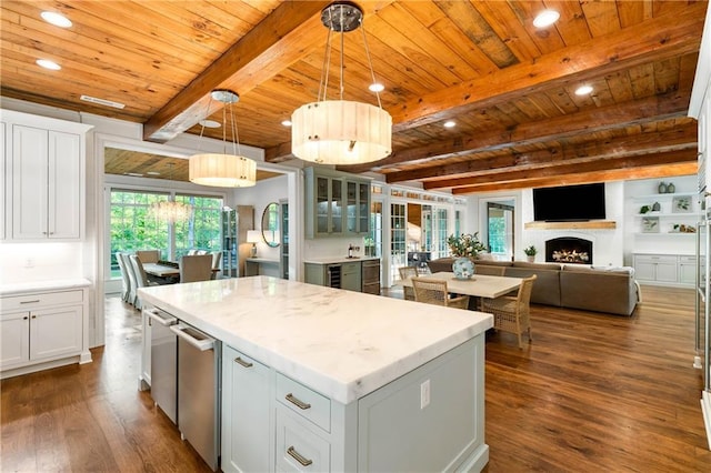 kitchen with dark wood-style floors, wood ceiling, a center island, recessed lighting, and a lit fireplace