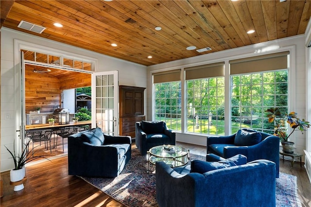 living room featuring wooden ceiling, wood finished floors, healthy amount of natural light, wood walls, and recessed lighting