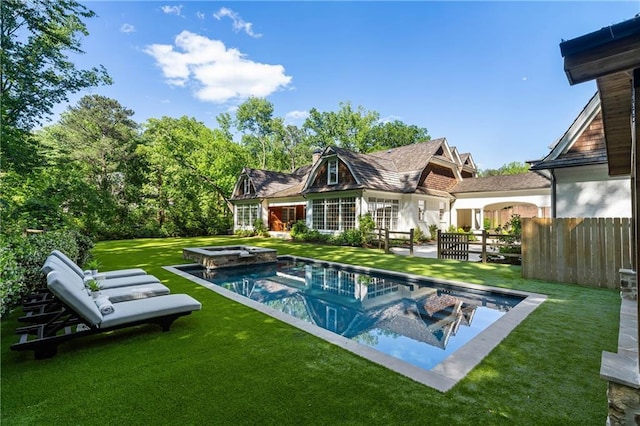 back of property featuring a patio and a pool with connected hot tub
