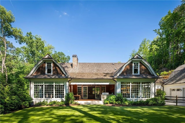 rear view of property with a chimney and a patio