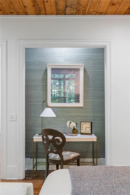 dining area view of wood ceiling and baseboards