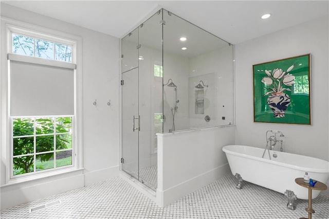 full bath featuring a shower stall, a soaking tub, tile patterned floors, and recessed lighting