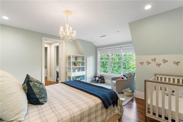 bedroom featuring wood finished floors, a chandelier, baseboards, recessed lighting, and vaulted ceiling