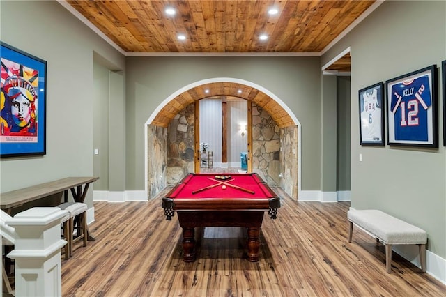 rec room featuring wood finished floors, recessed lighting, wooden ceiling, arched walkways, and crown molding
