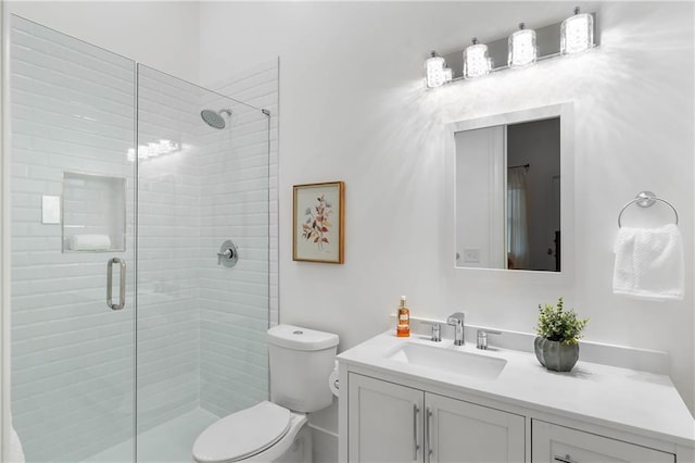 full bath with a stall shower, toilet, and vanity