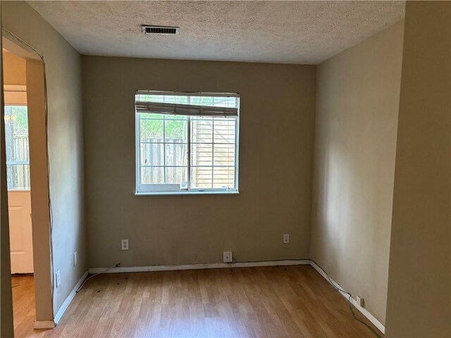 2834 Royal Path Ct, Decatur, GA 30030 - unfurnished room with visible vents, a textured ceiling, baseboards, and light wood-style flooring