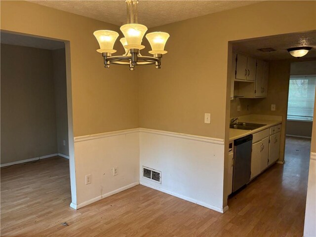 2834 Royal Path Ct, Decatur, GA 30030 - kitchen with stainless steel dishwasher, light wood-type flooring, a textured ceiling, visible vents, and a sink