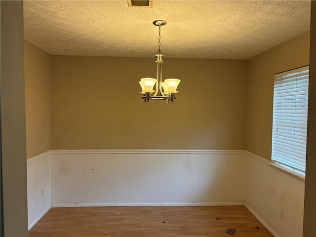 2834 Royal Path Ct, Decatur, GA 30030 - unfurnished dining area with a chandelier, a textured ceiling, baseboards, and wood finished floors