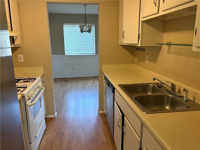 2834 Royal Path Ct, Decatur, GA 30030 - kitchen with a notable chandelier, dishwasher, a sink, white range with gas cooktop, and white cabinetry