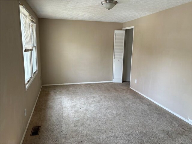 2834 Royal Path Ct, Decatur, GA 30030 - spare room featuring carpet, visible vents, a textured ceiling, and baseboards