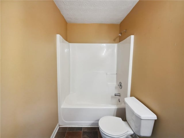 bathroom featuring tile patterned flooring, a textured ceiling, toilet, and shower / bathtub combination