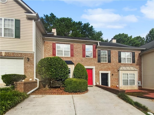 townhome / multi-family property featuring a garage