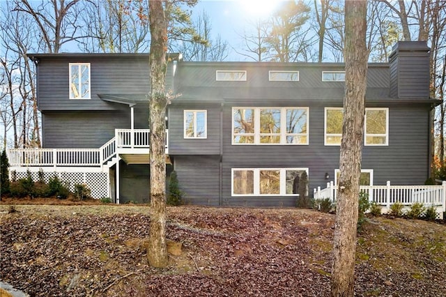 rear view of house featuring a wooden deck