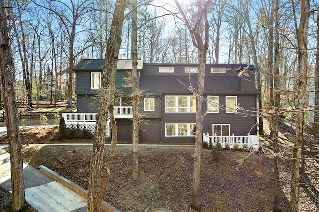 back of house featuring a wooden deck