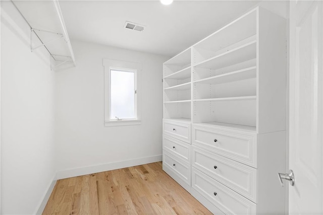 walk in closet featuring light hardwood / wood-style floors