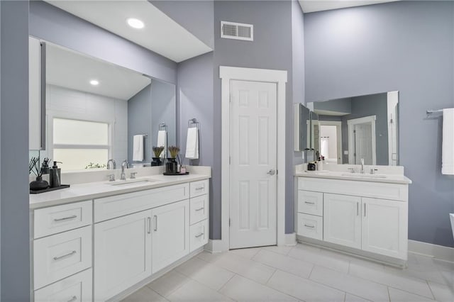 bathroom featuring tile patterned flooring and vanity