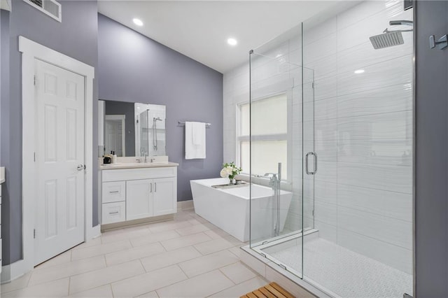 bathroom with tile patterned floors, vanity, and separate shower and tub